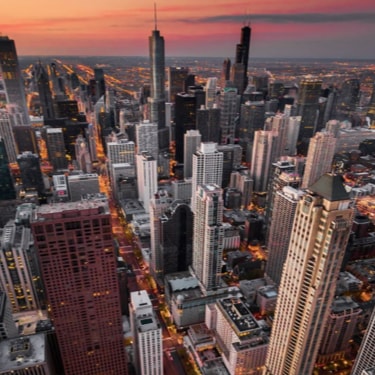 a birdseye view of a busy city during sunset